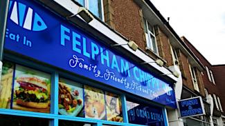 Shop front with signs & food colour prints